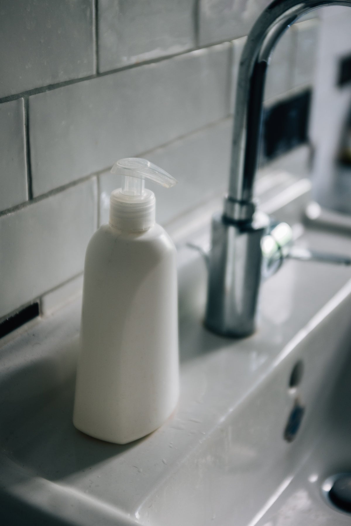 Body mist bottle on a porcelain sink