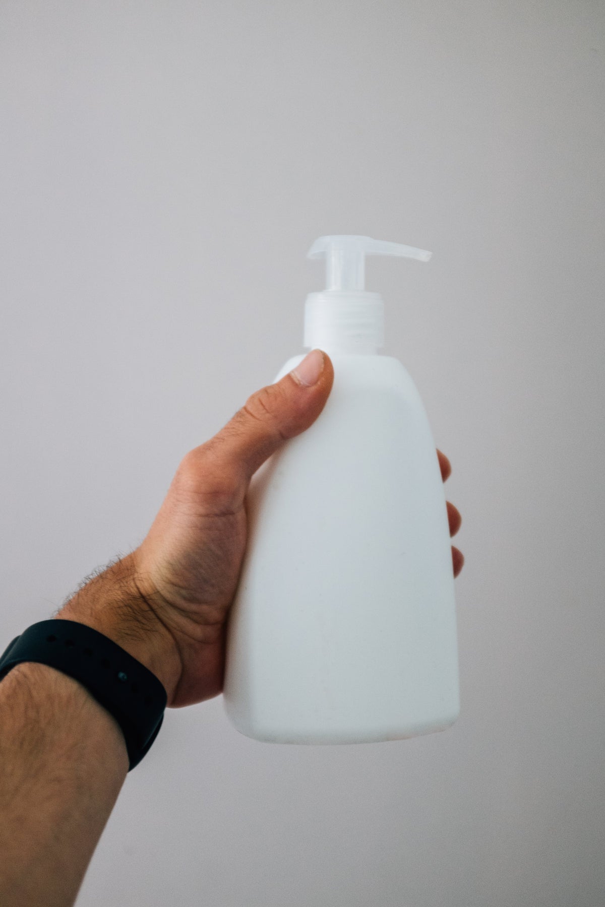Hand holding a body mist bottle