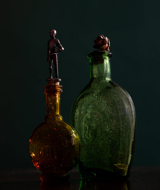 Two ornate glass attar bottles